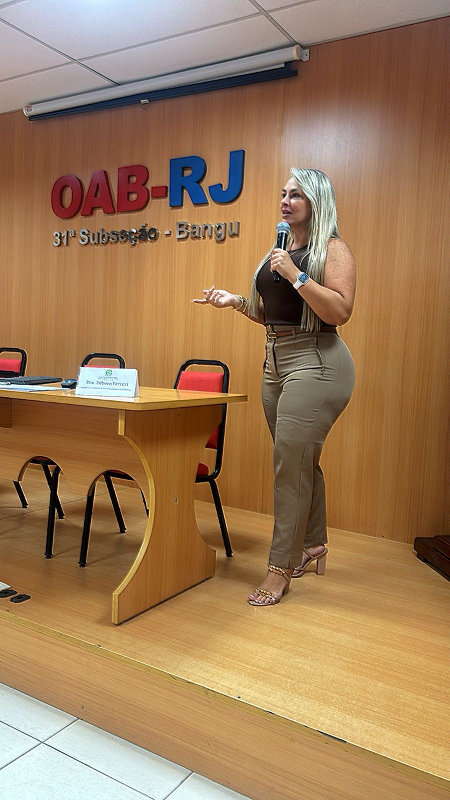Dra. Débora Ferrari Braga falando ao microfone na OAB-RJ, 31ª Subseção Bangu